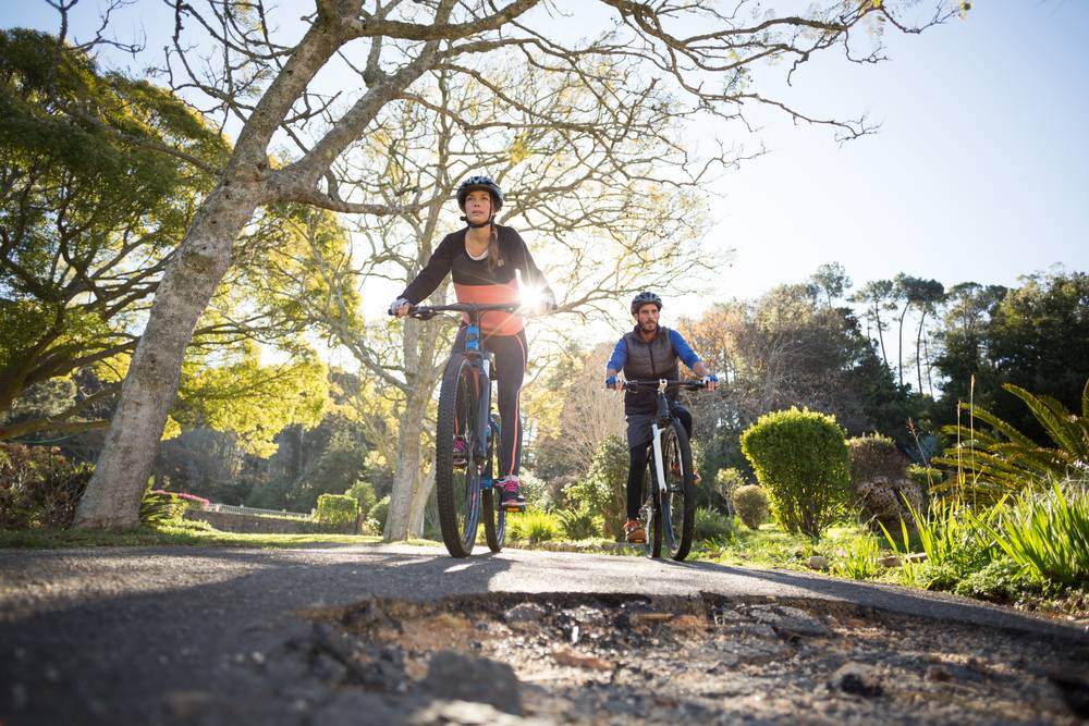 Smiling biker couple cycling on the countryside road-1