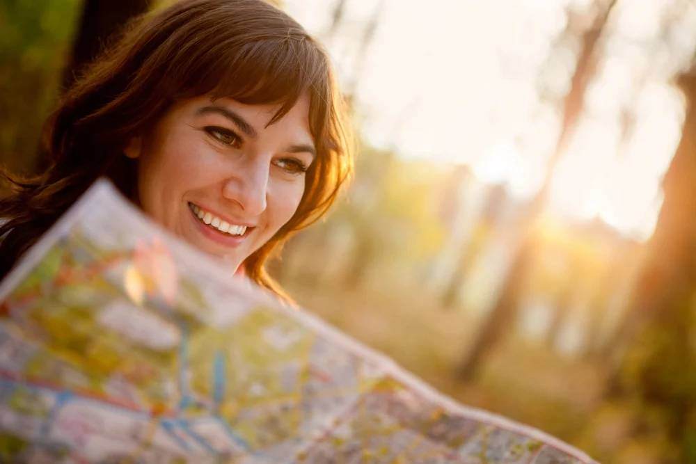 female explorer looking at a map outdoors